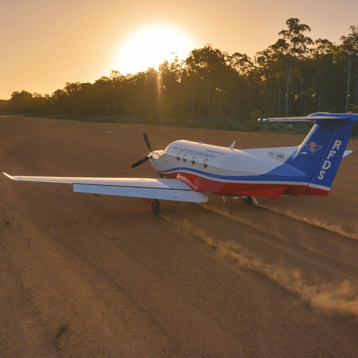 Royal Flying Doctor Service PC-12 aircraft landing on an outback airstrip